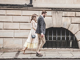 Professional couple walking in city street